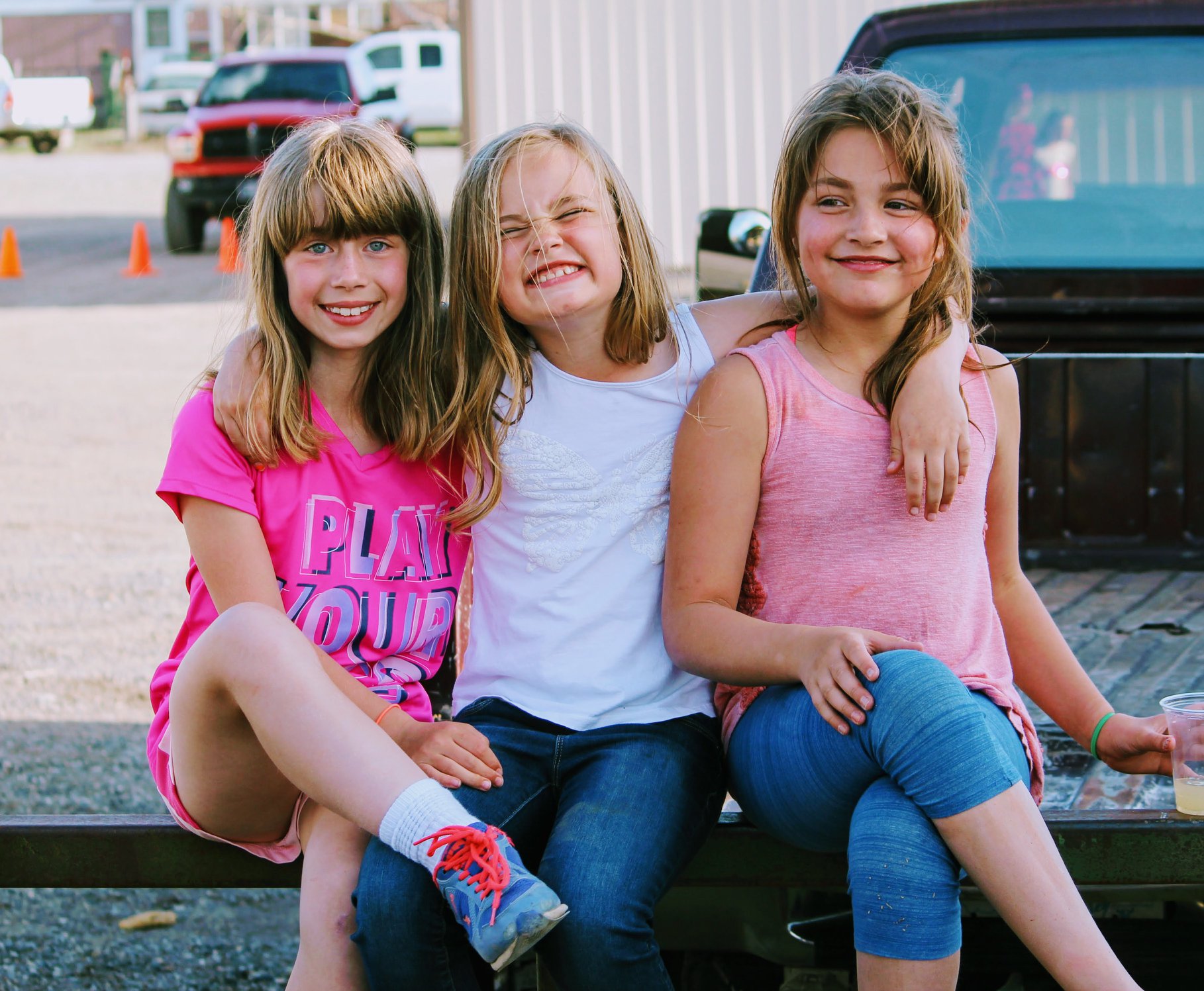 3 smiling girls on bench